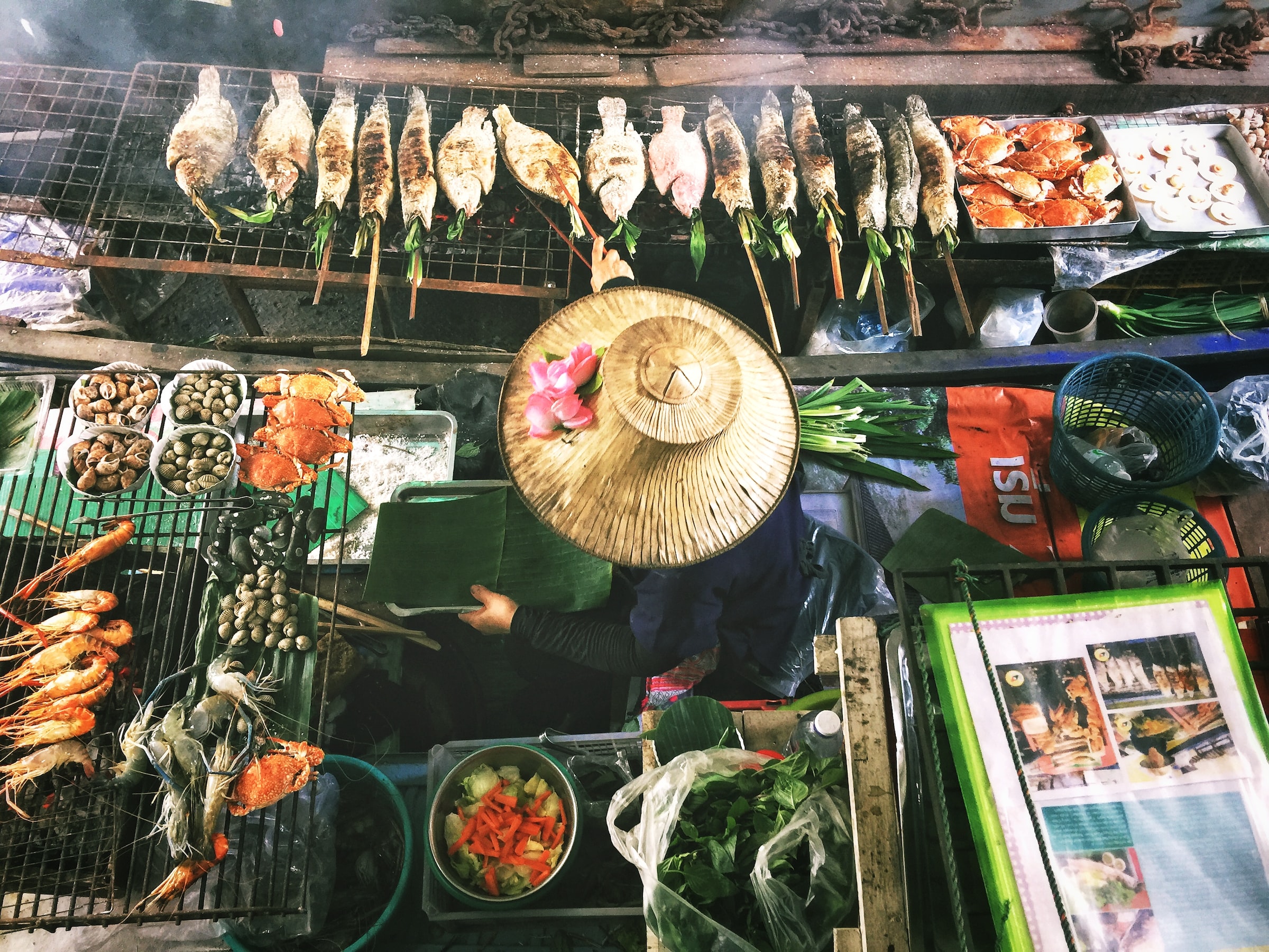 Woman sitting in the centre of a lively food market