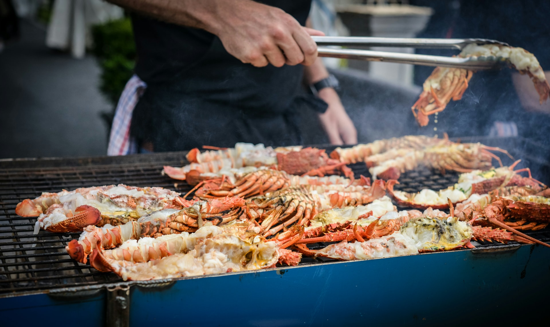Man grilling crabs on a bbq