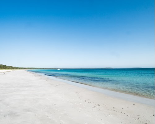 Wide stretch of untouched white sand beach and calm turquoise sea