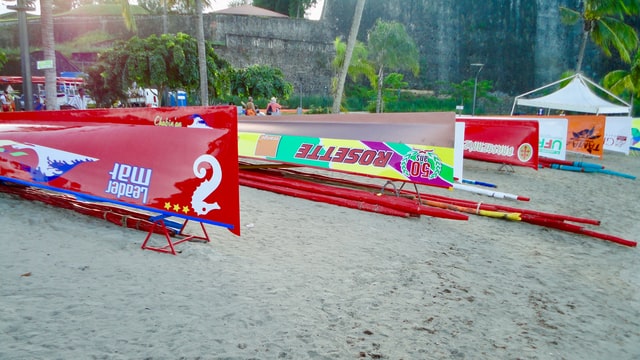 Colourful yole boats lined up on a beach in Martinique