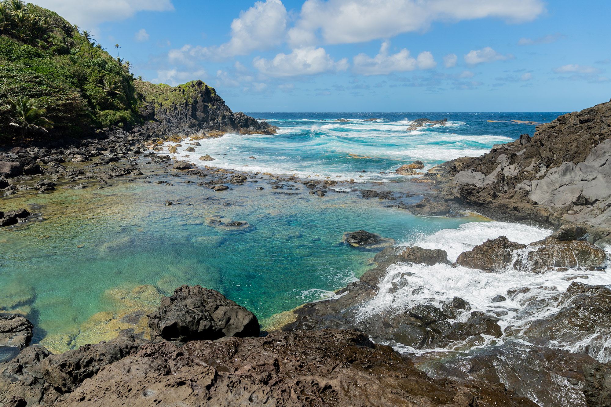 Turquoise pool of water next to the sea in a Caribbean island 