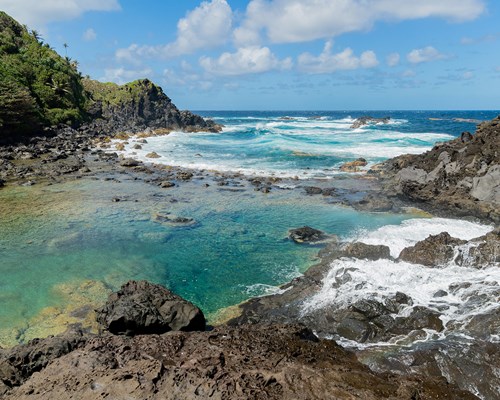 Turquoise pool of water next to the sea in a Caribbean island