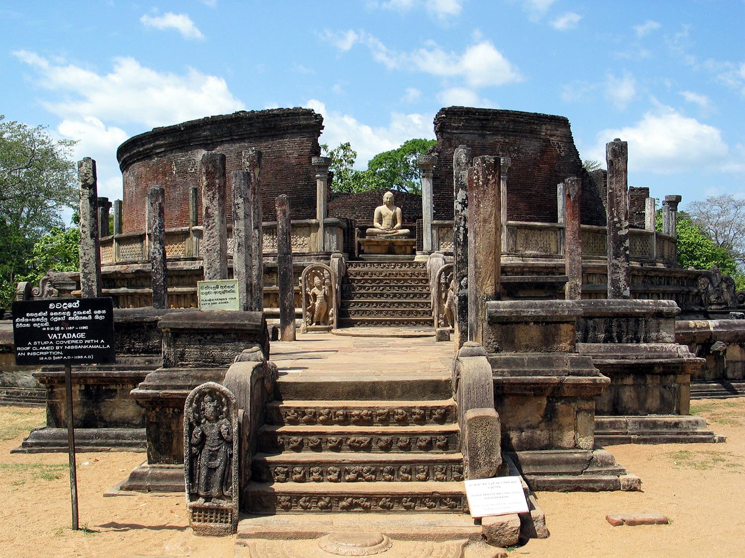 Circular ruins on a raised platform with statues of Buddha