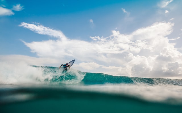 Man surfing a small wave in the Caribbean Sea