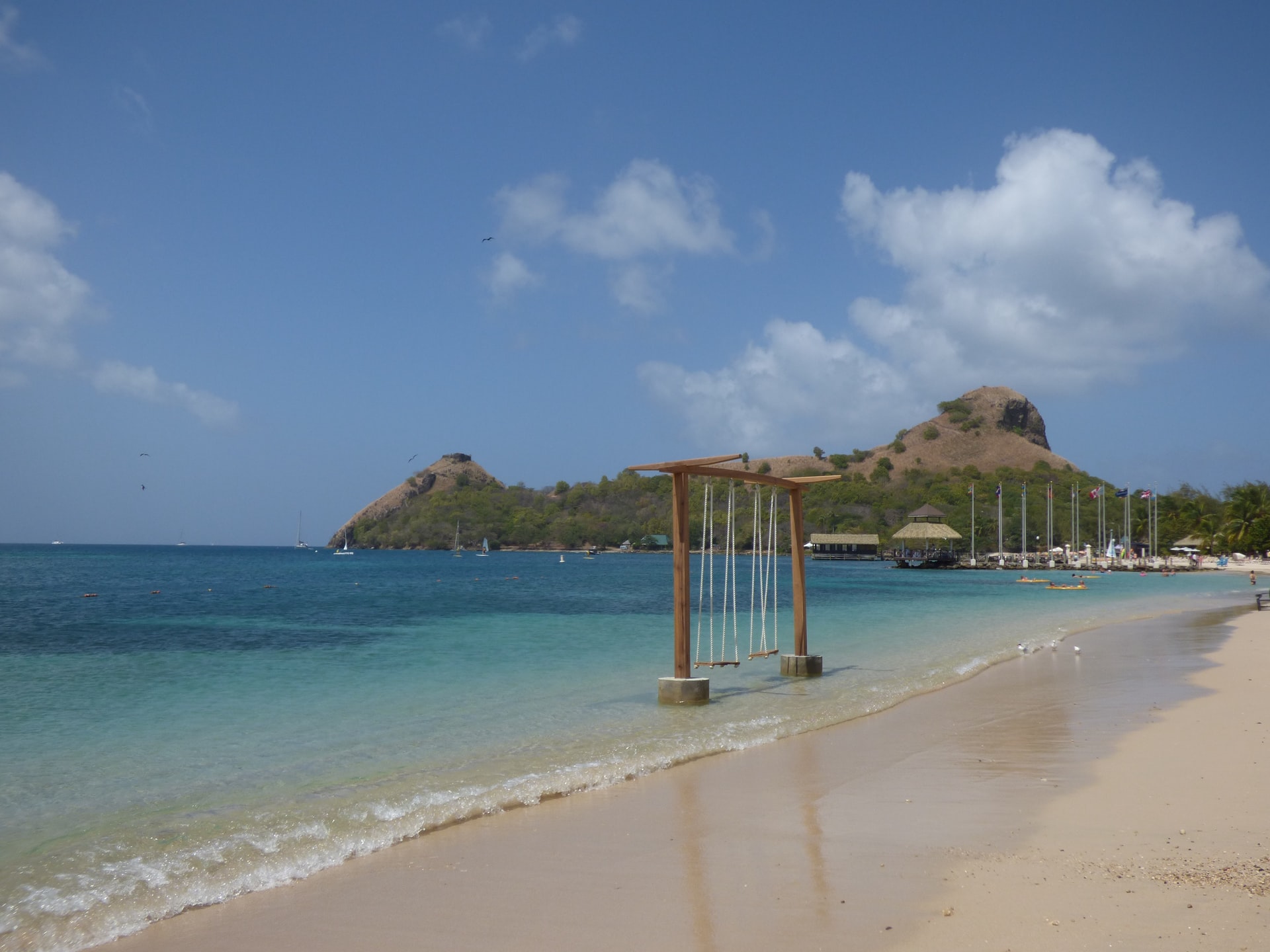 Sea swing on tropical beach with white sand and turquoise water