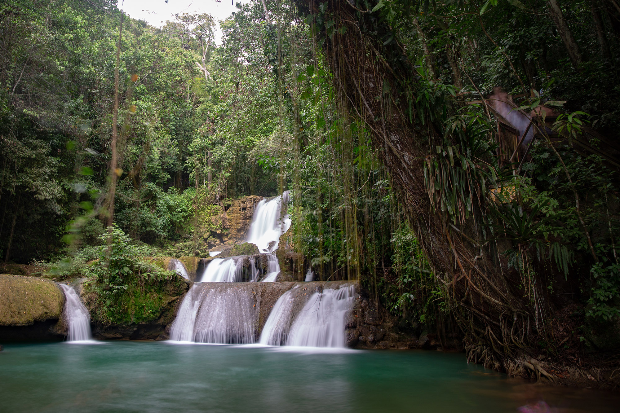Cascading waterfall over rocks in the middle of the jungle
