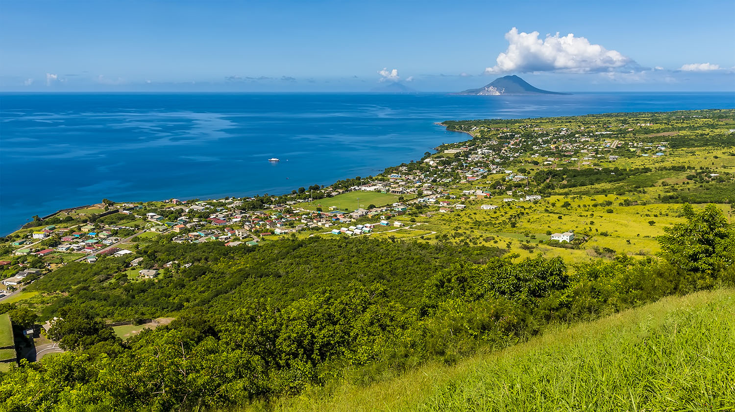 View from hill of a coastal town on a tropical island 
