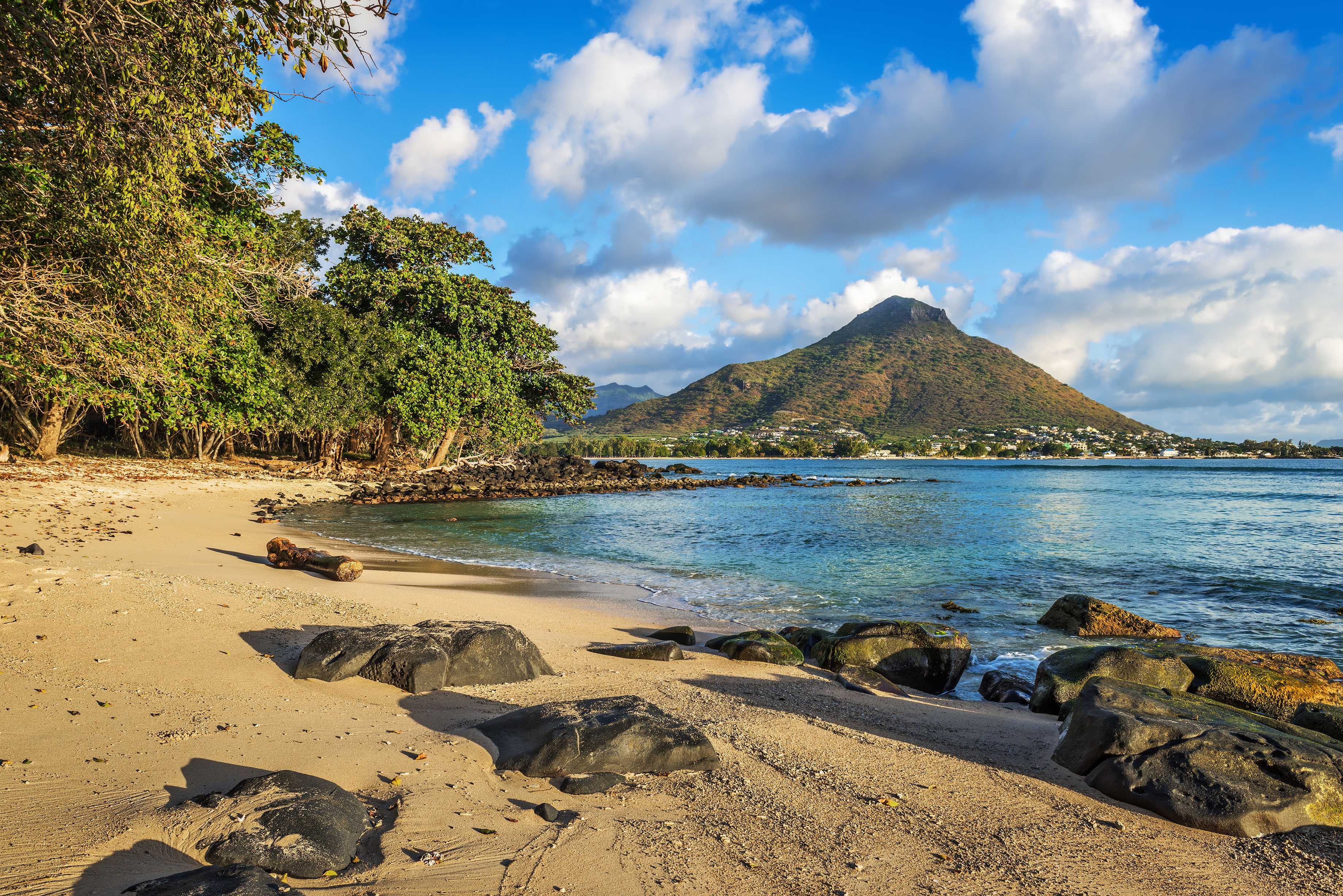 Tamarin Beach with rocks and a volcano in the background