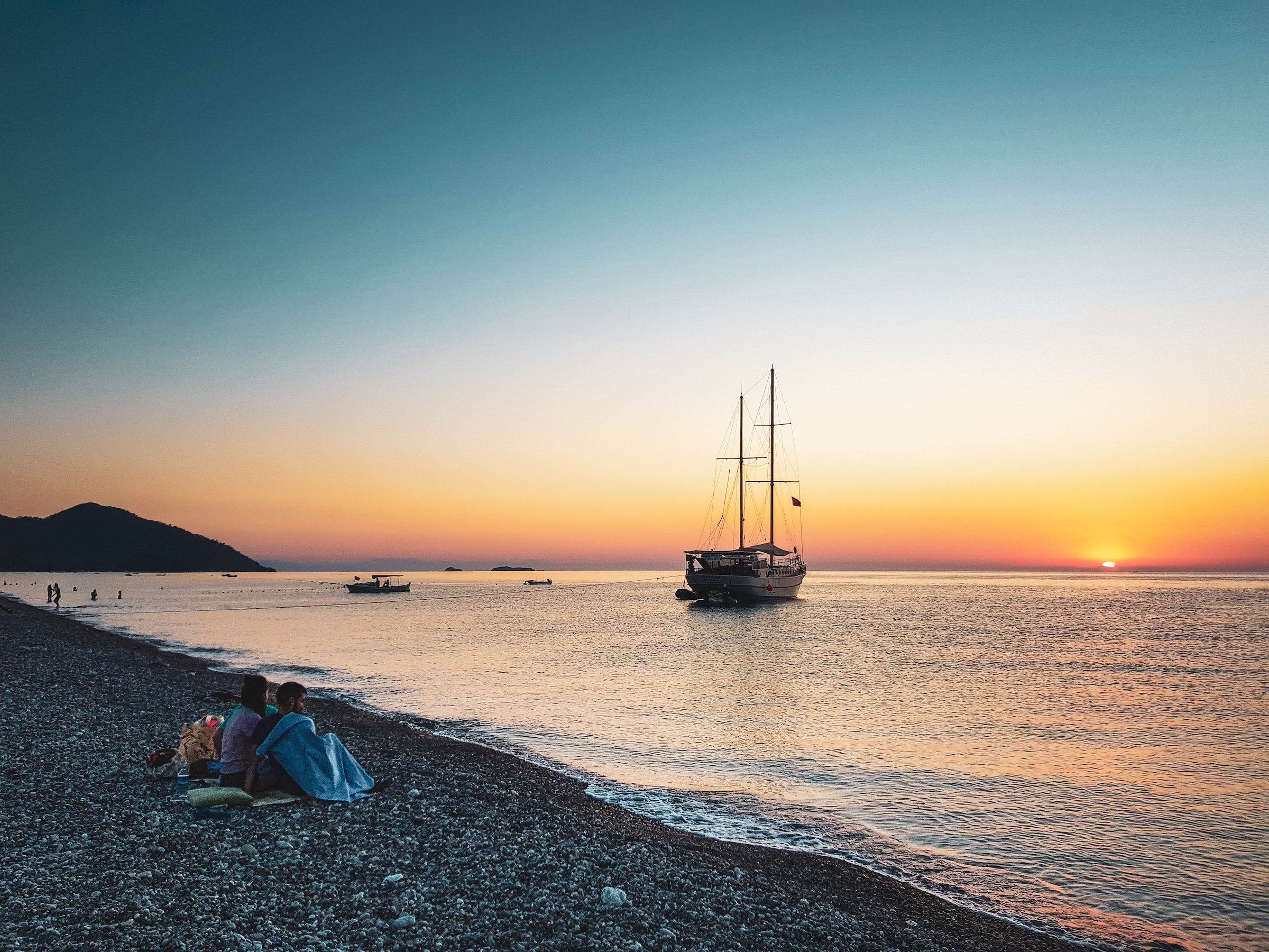 Two people watching a boat on Cirali Beach