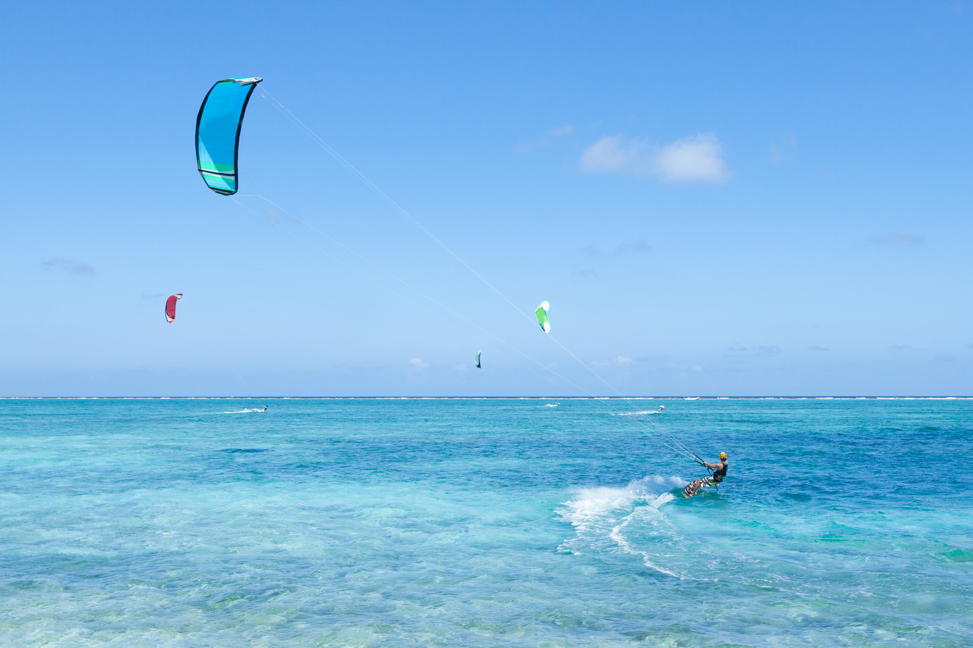 Kite surfer on clear blue tropical water