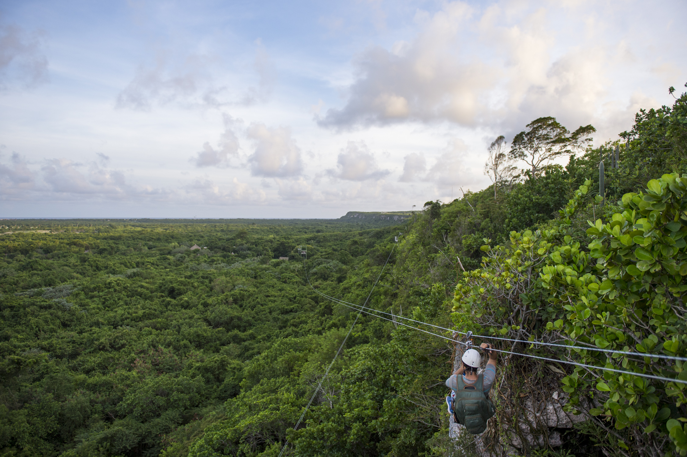 A woman zip lining through the forest in Punta Cana