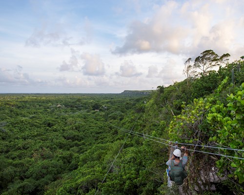 A woman zip lining through the forest in Punta Cana
