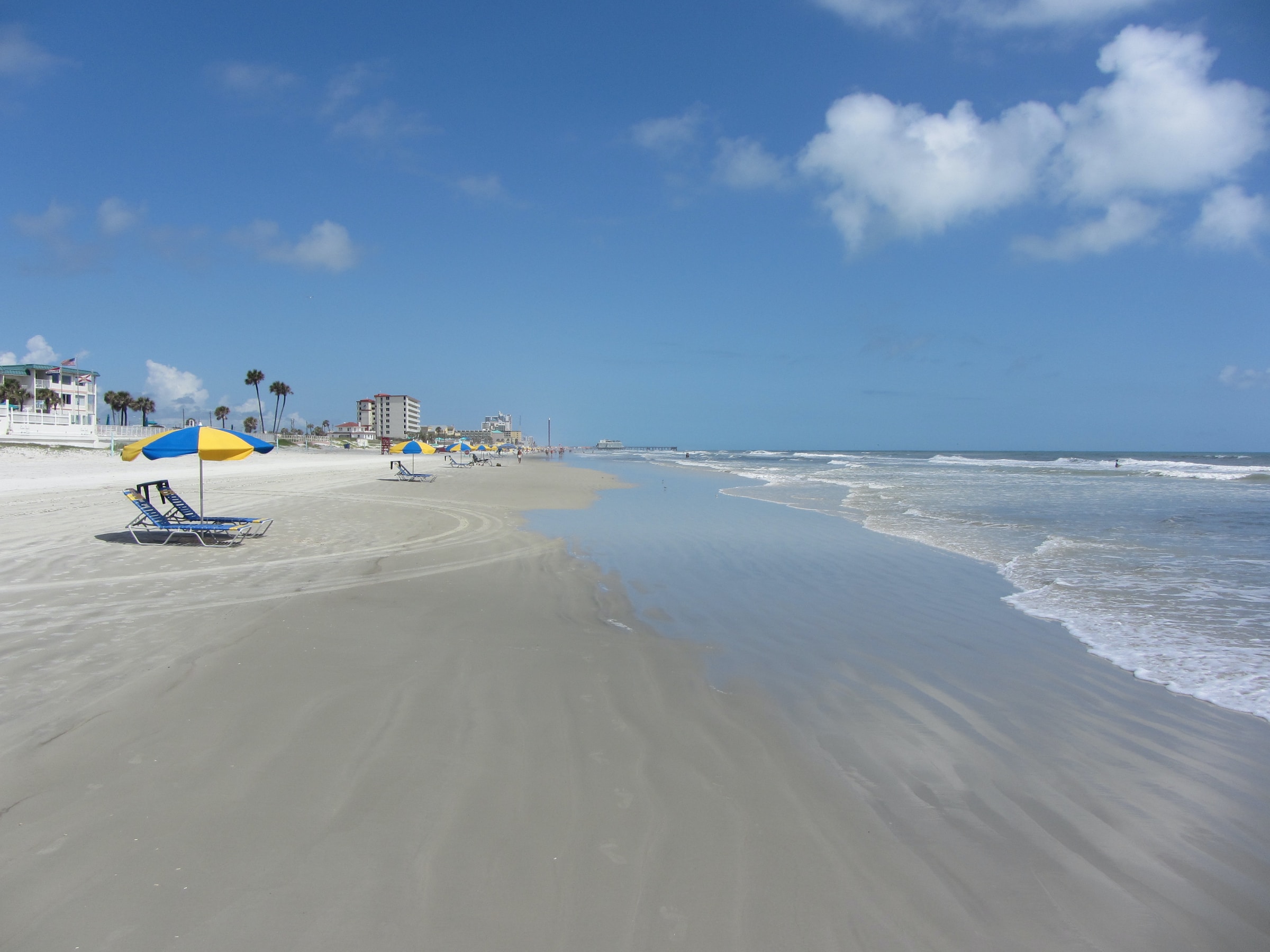 A vast beach dotted with umbrellas and sun loungers