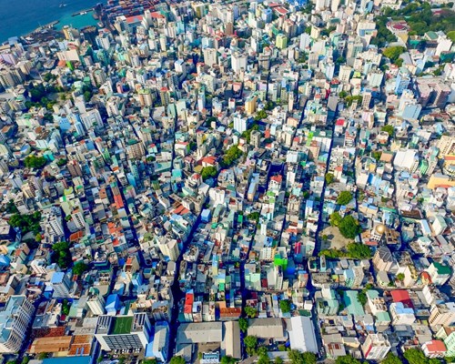 Aerial view of a city crammed with high rise buildings and narrow streets