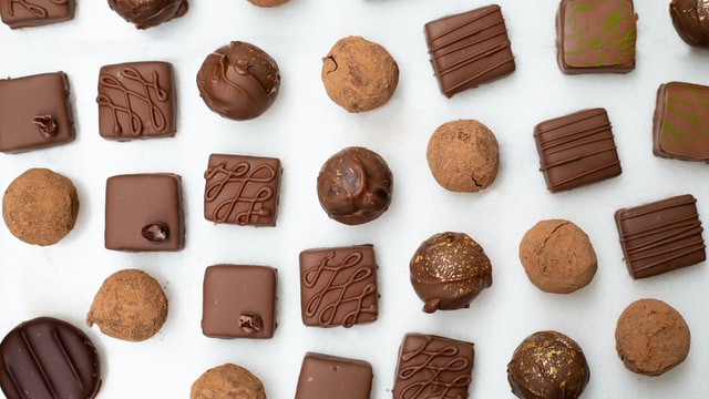  Selection of chocolate truffles on a white background