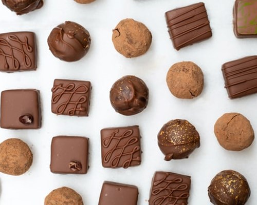 Selection of chocolate truffles on a white background