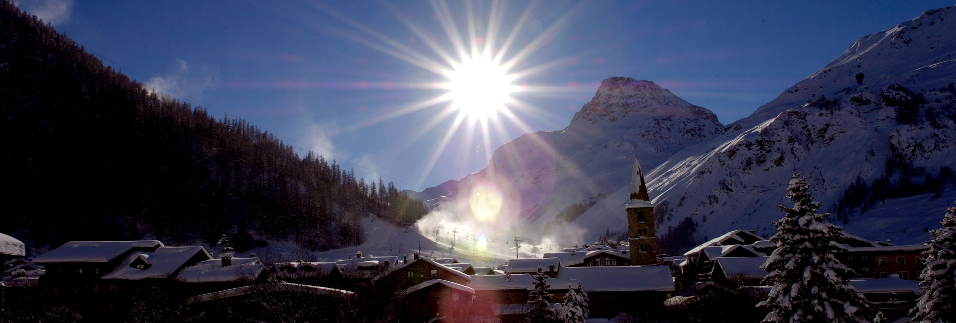 Val d'isere ski hotels in winter sunshine with snowy mountains behind