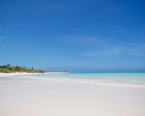 Wide white sand beach with calm bright blue sea