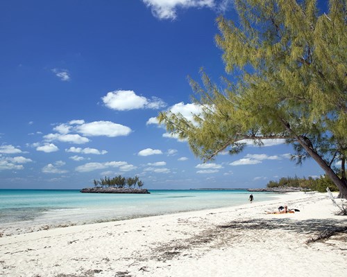 Person walking along the sea on a wild tropical beach