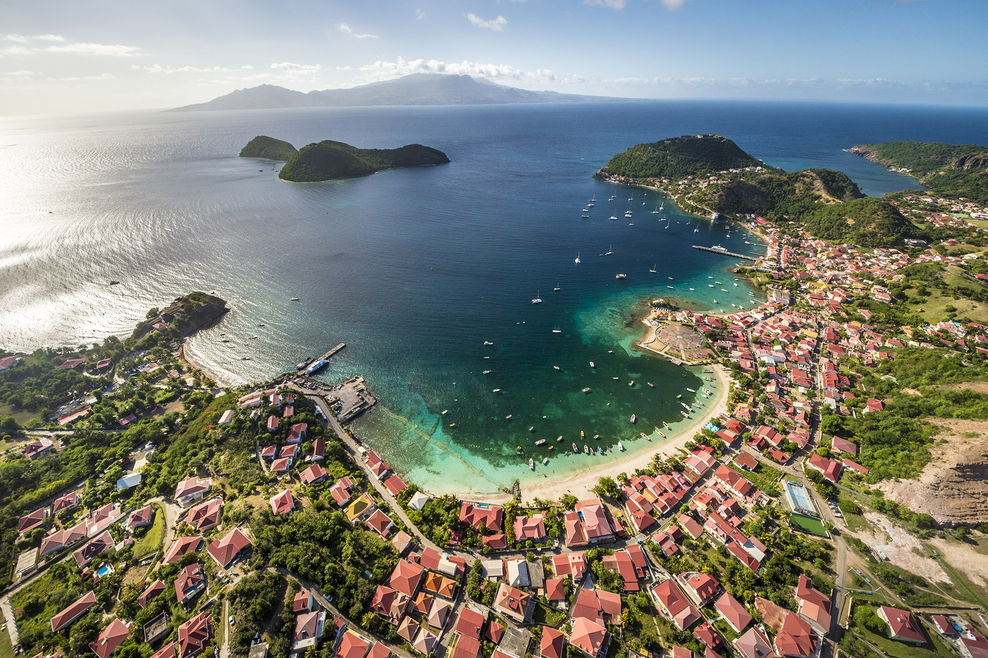 Aerial view of Les Saintes town, white sand coastline and small surrounding islands