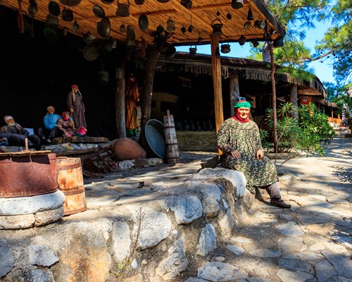 A woman sitting in Kemer Folkloric Nomad Park