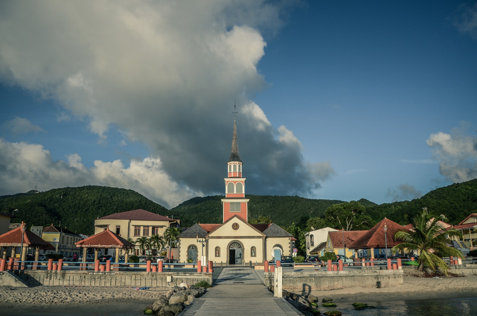 Red and white church building by the docks in Fort-de-France