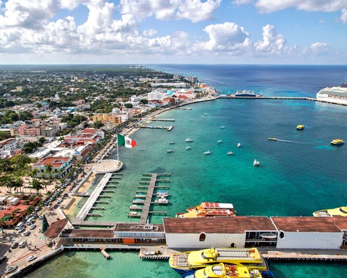 Aerial view of a cruise ship docked in a port of a tropical island