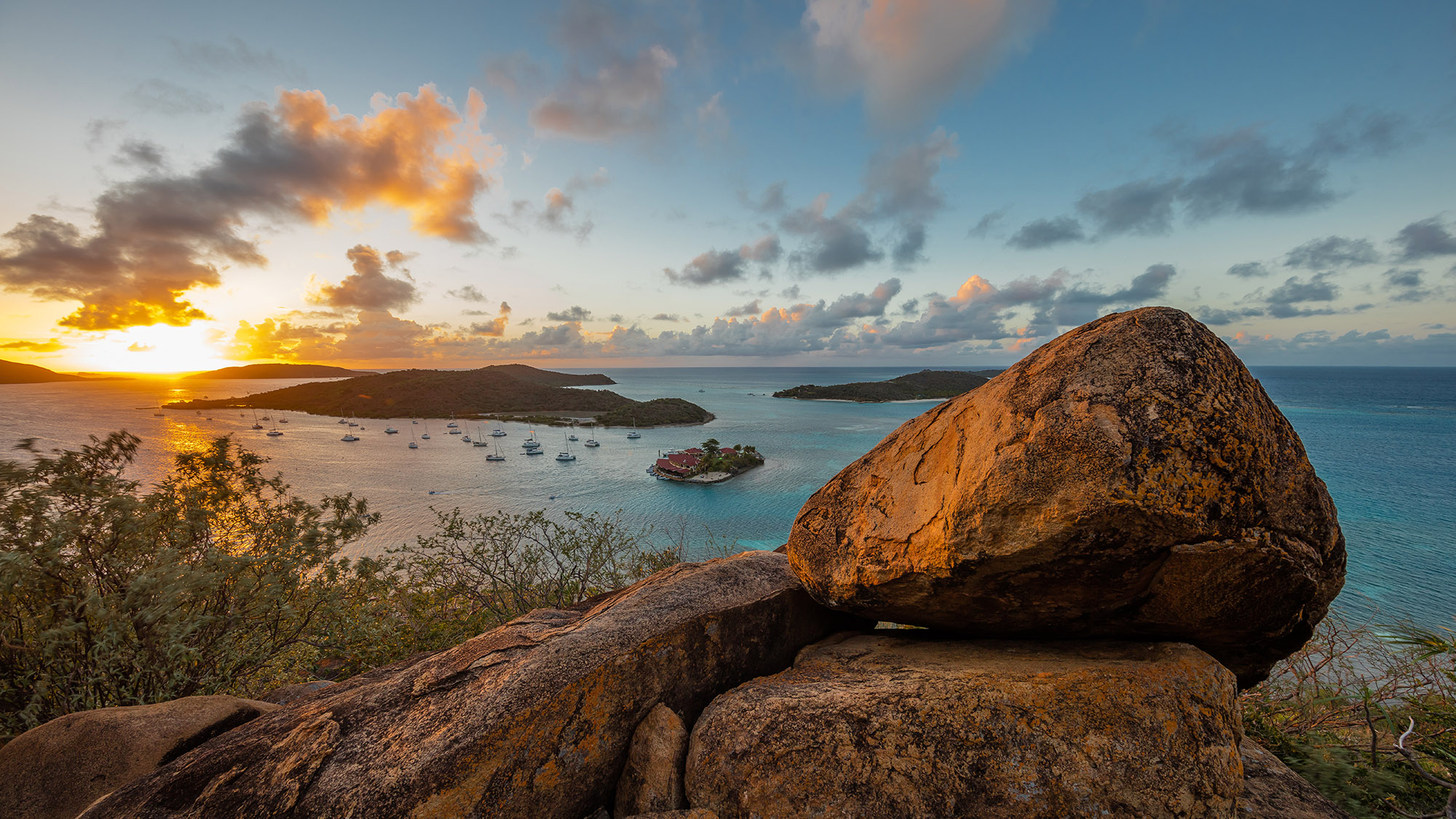 Mountain view looking out to sunset at sea and surrounding tropical small islands