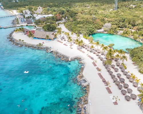 A lagoon in front of a pristine white sand beach and the Caribbean ocean