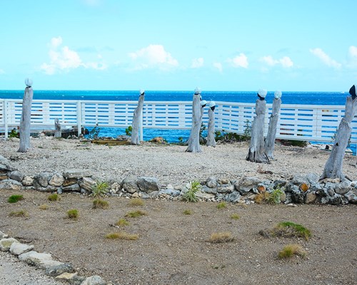 Tall statues on the edge of a cliff