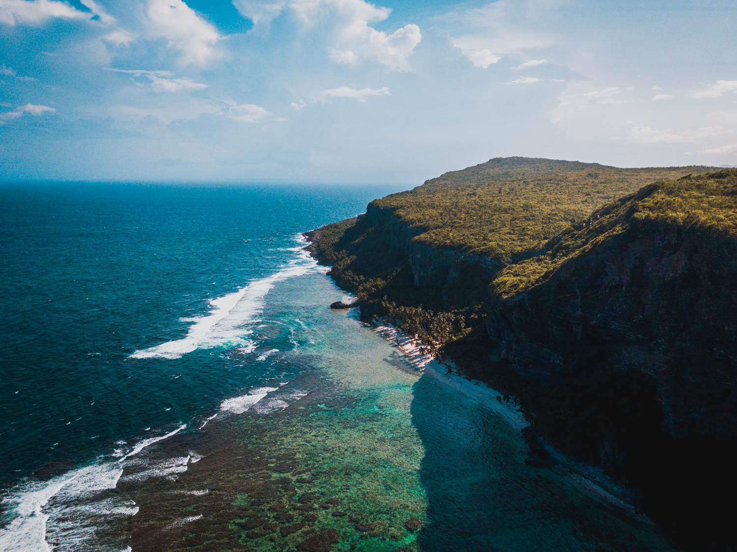 Aerial view of headland and cliffs on a tropical island 