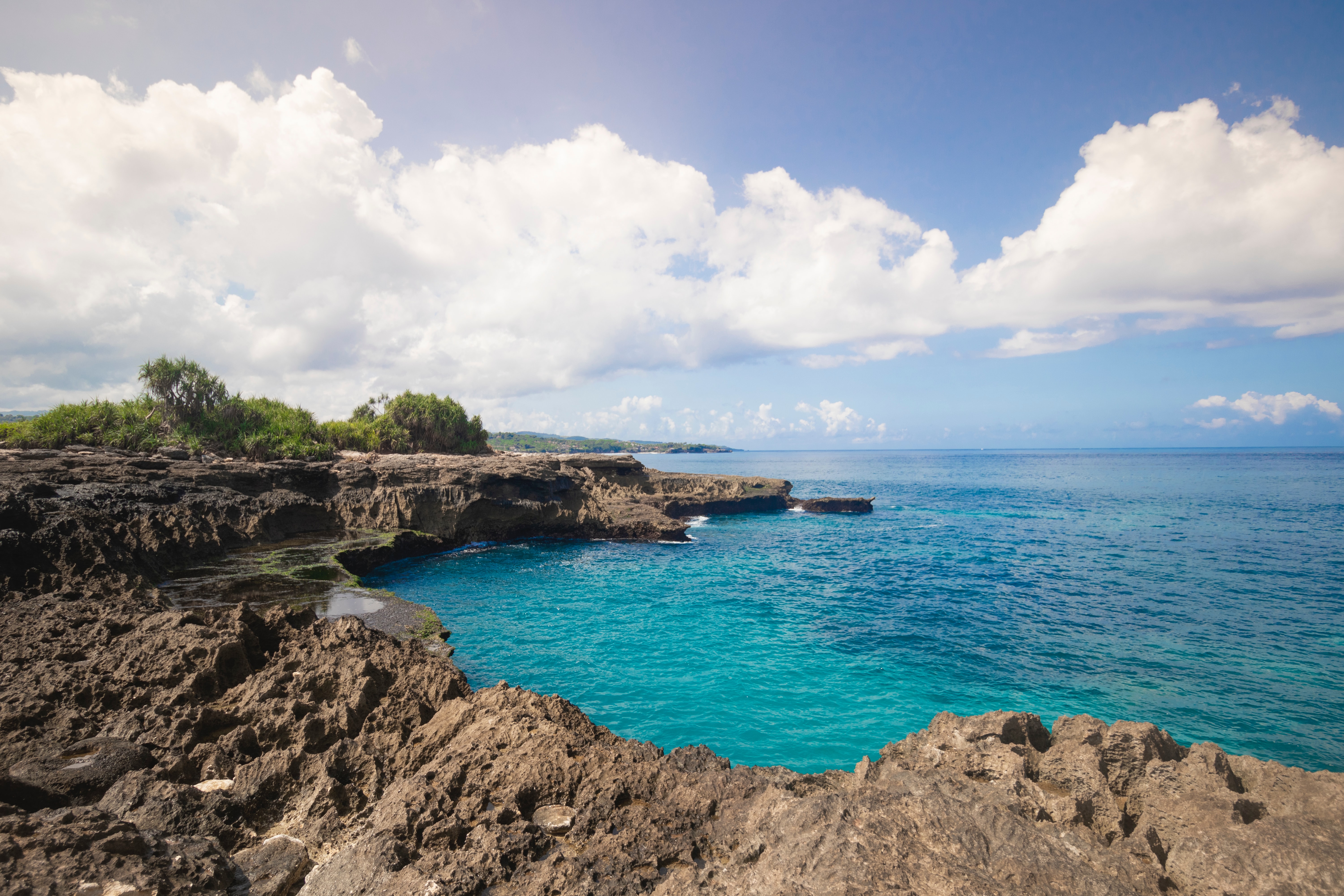A blue lagoon edged by rocky outcrops