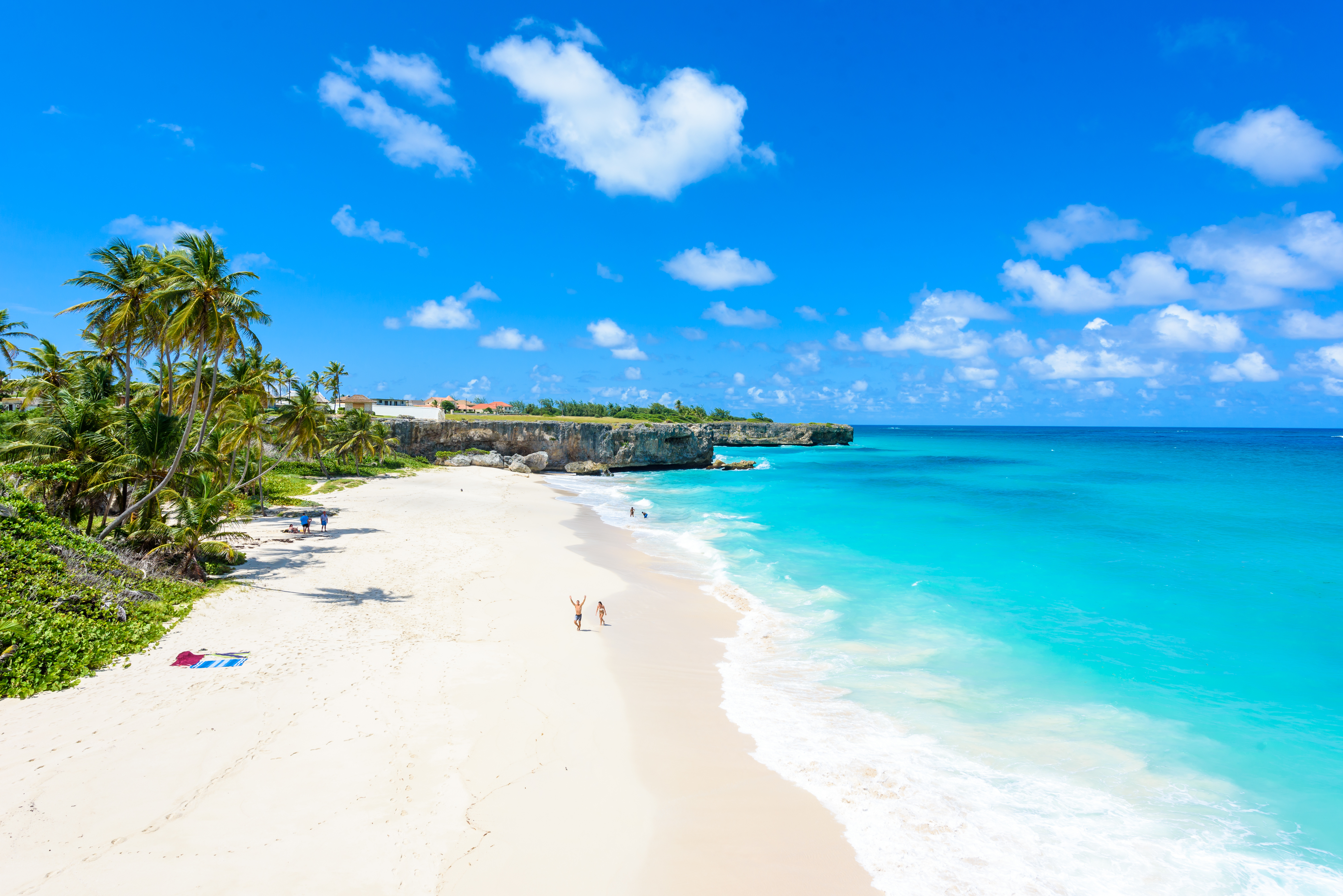 Couple walking along tropical beach
