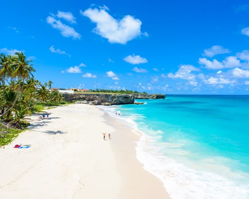 Couple walking along tropical beach