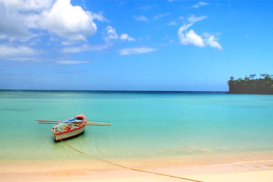 Small boat docked up on the beach at Morne Rouge Bay