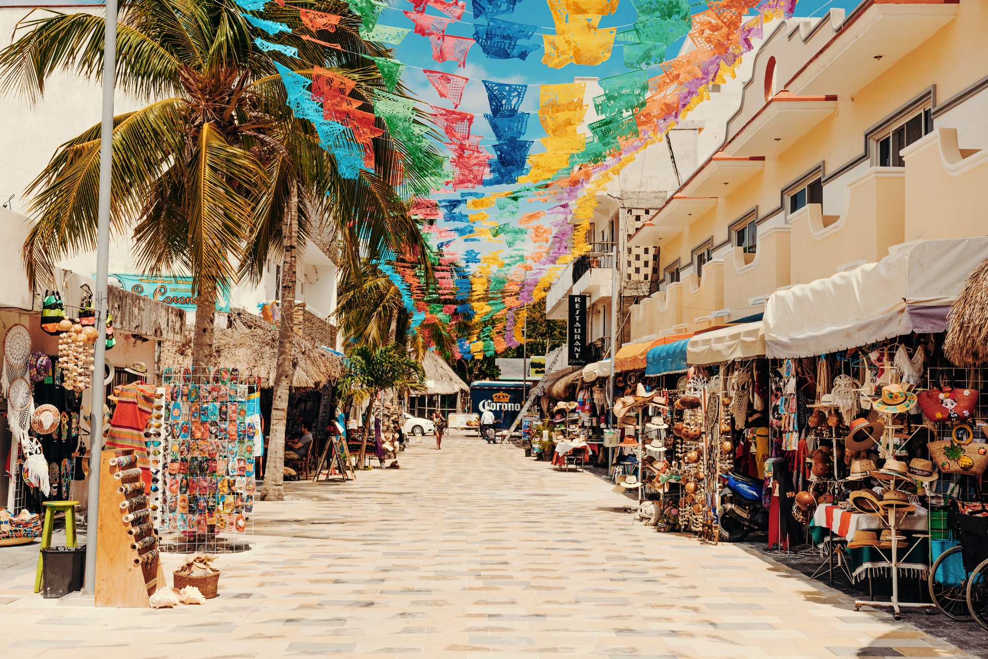 Street of beach shops in Cozumel with colourful flag bunting overhead