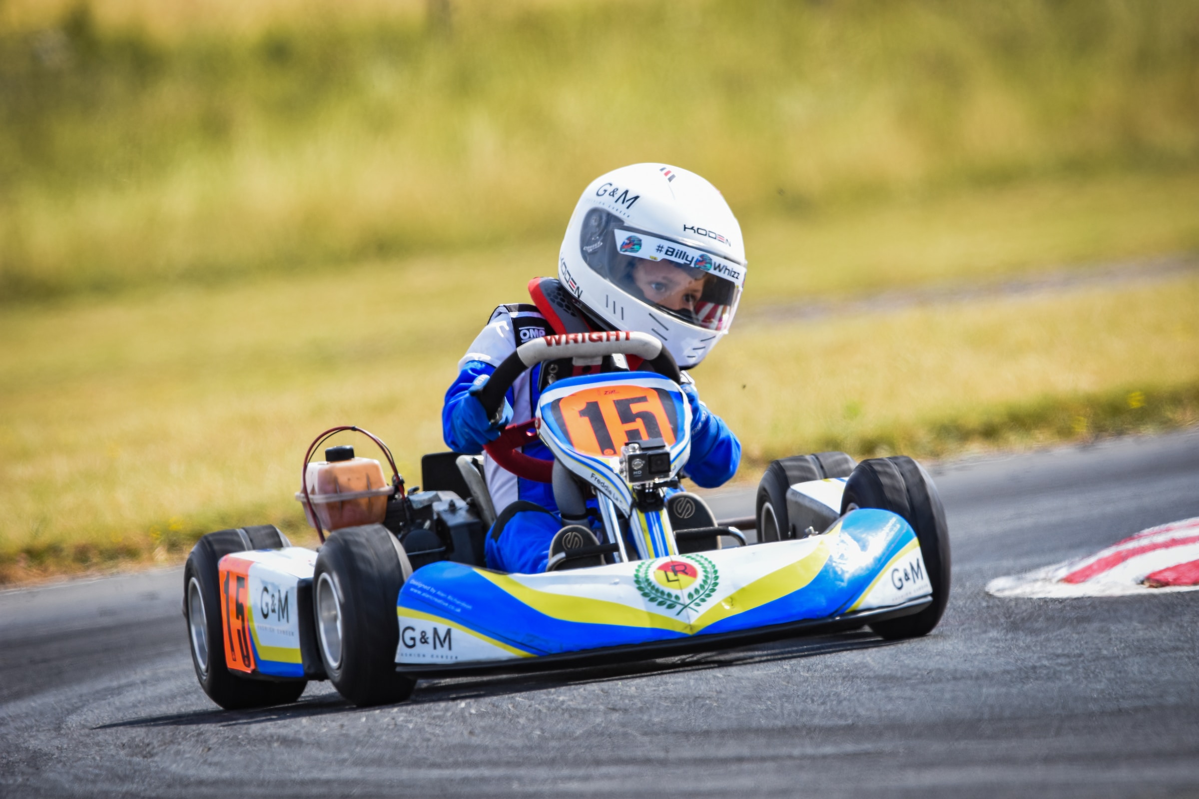 A boy go karting at a racing track