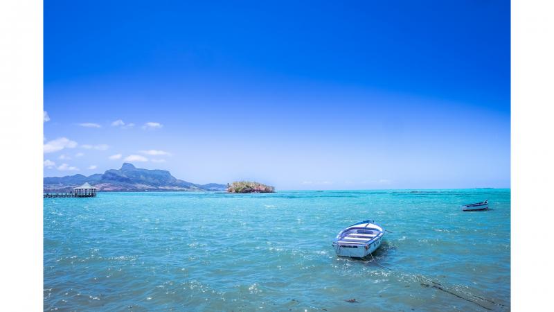 View of boats sailing on blue sea and blue skies