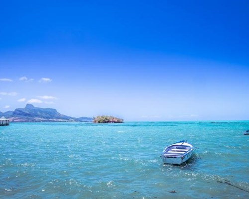 View of boats sailing on blue sea and blue skies
