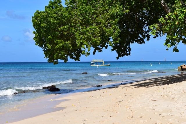 Tour boat near the shores of a tropical beach 