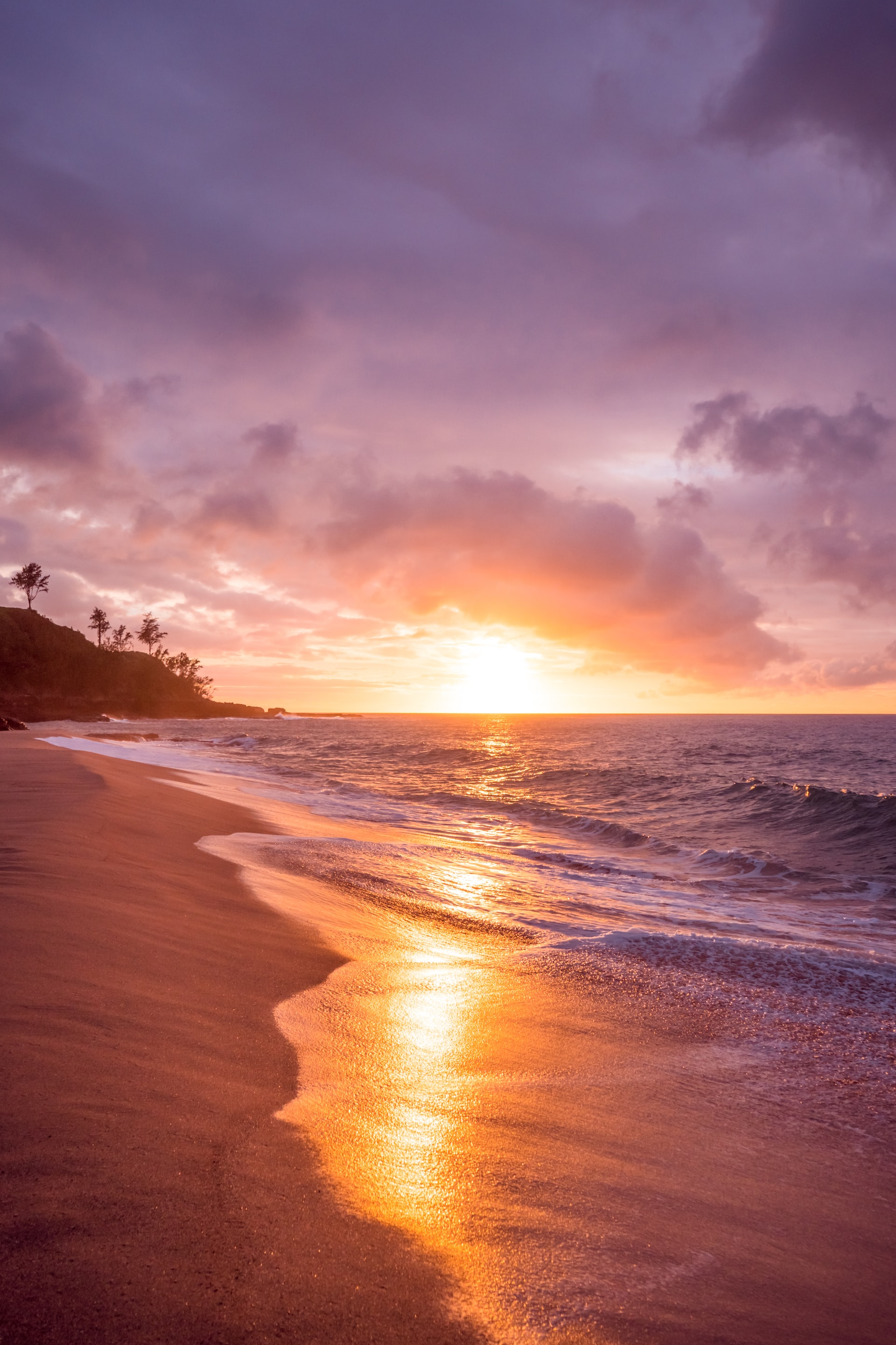 Beautiful shot of a lavender-pink sunset on a beach