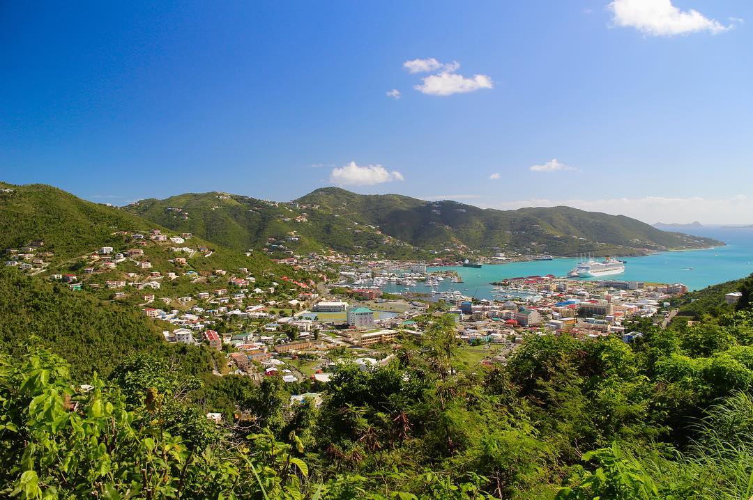 Mountain view looking out to colourful buildings and green mountains - Road Town, Tortola 