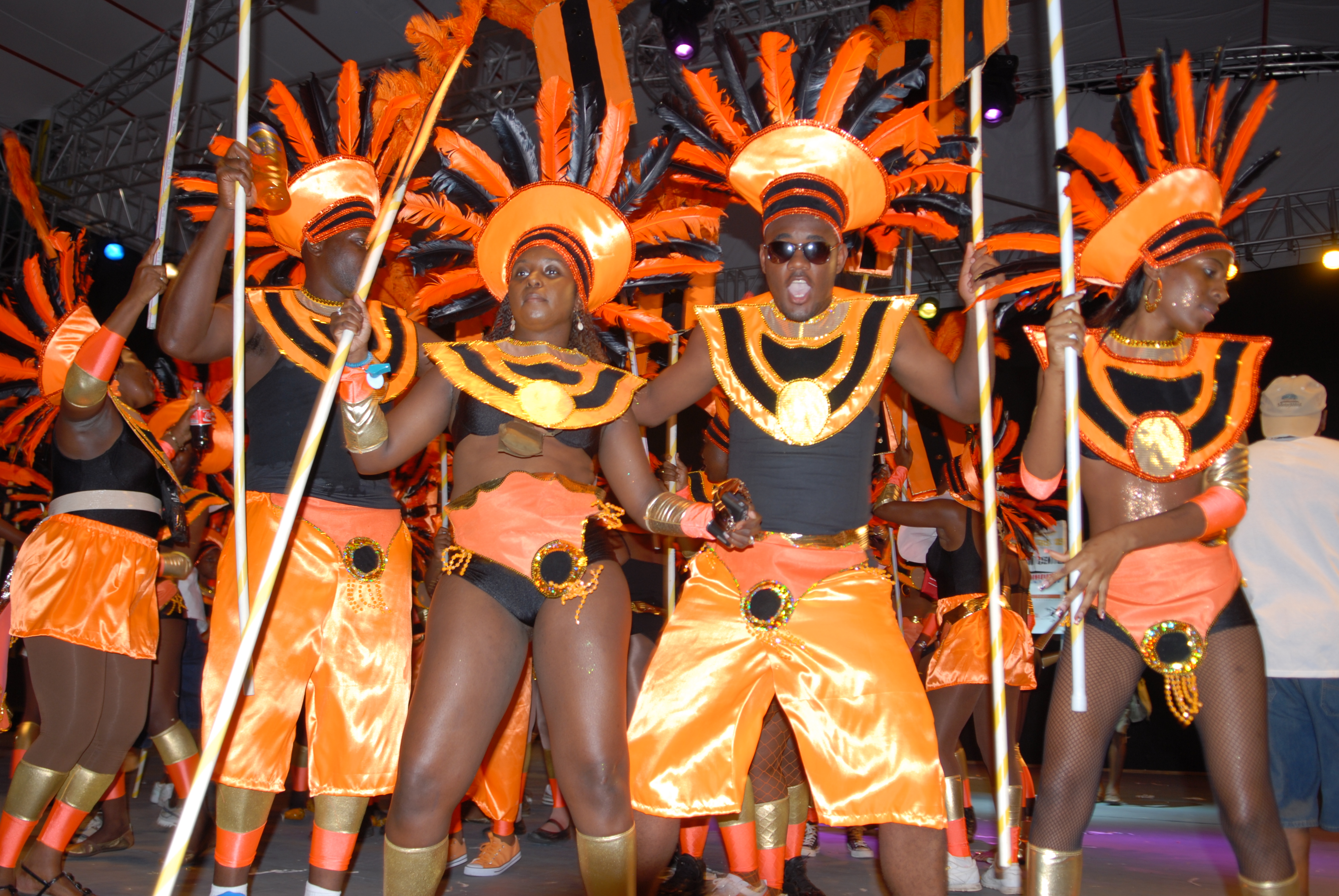 People dressed up in orange Carnival Costumes