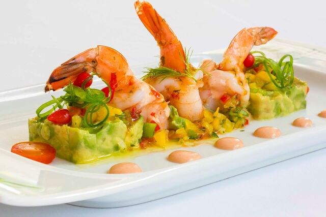 Prawns and fresh ingredients on a white plate 