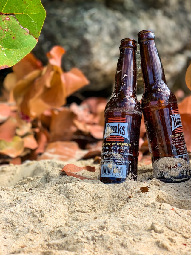 Close up of Banks beer bottles on a beach