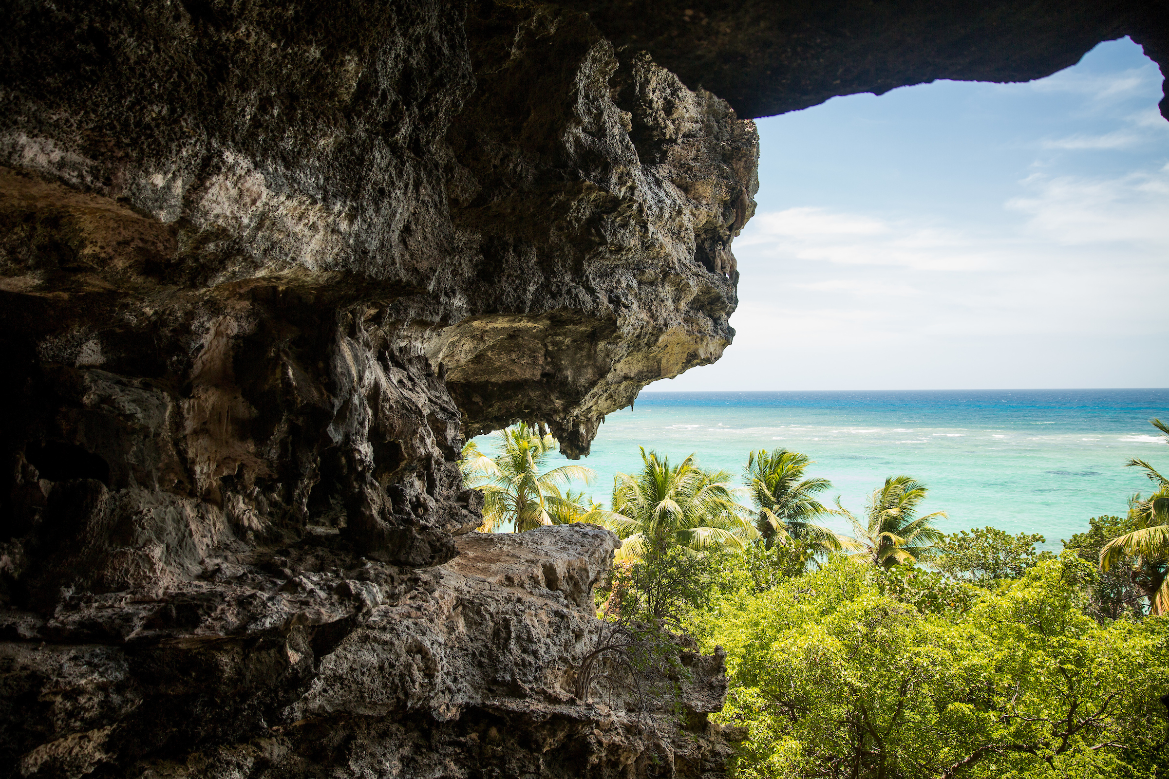 Cave exit with an landscape view of turquoise seaside