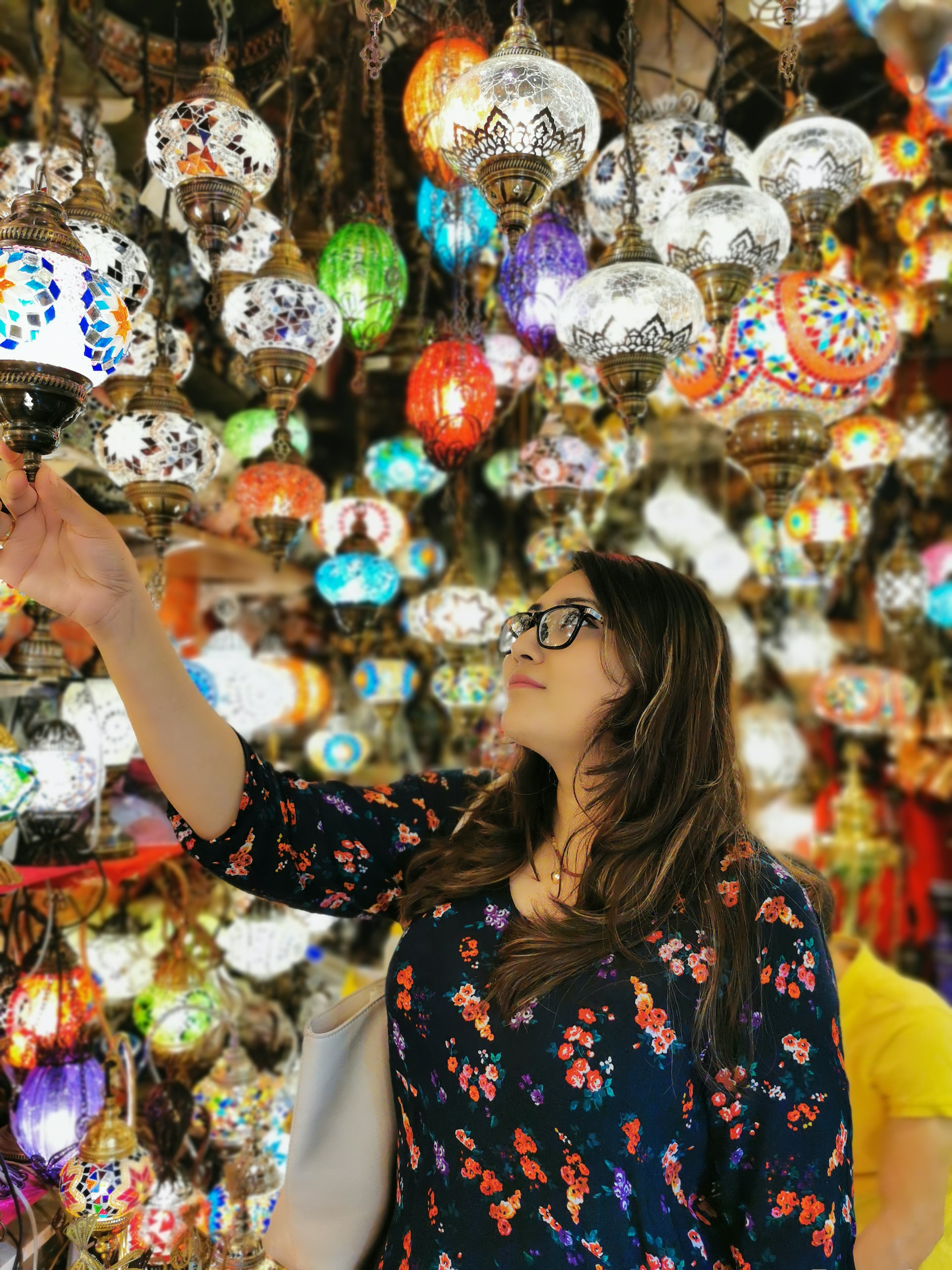 A woman looking at a lamp display at the Grand Bazaar
