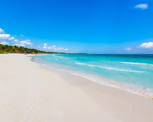 Beautiful coastline in Mexico with white sand beach and calm bright blue sea