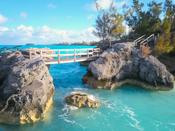 Rocky bridge walkway across blue sea