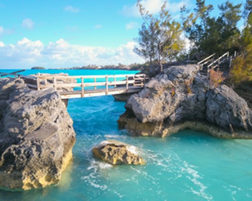 Rocky bridge walkway across blue sea